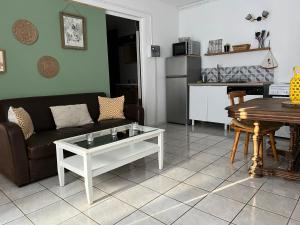 a living room with a couch and a table at Gîte du vieux moulin in Ravilloles +10 photos