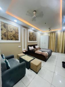 a living room with a bed and a couch at cozy noida studio, super comfy!!!! in Noida +4 photos