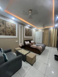 a living room with a bed and a couch at cozy noida studio, super comfy!!!! in Noida