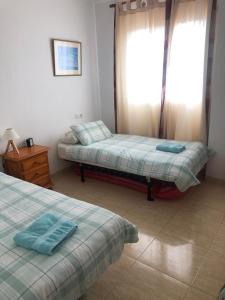 a bedroom with two beds and a window at Vicente Buades in Port de Pollensa