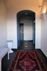 a hallway with a rug on the floor and a couch at La Perla di Boccadasse in Genoa +28 photos