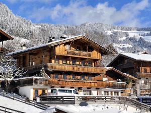 a large wooden building in the snow at Ferienwohnung Haus Sama in Alpbach
