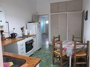 a kitchen with a table and chairs and a refrigerator at Chalet Ferrari in Mina Clavero
