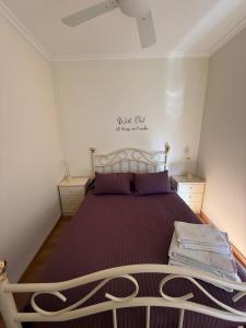a bedroom with a large bed with purple sheets at Casa Manuel in Manteigas