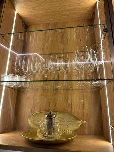 a cabinet with wine glasses and a plate in it at Sungora sun&ski resort in Slavske +60 photos