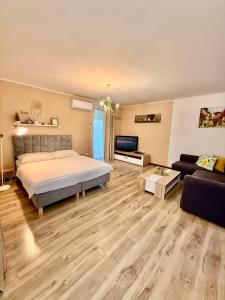 a large bedroom with a bed and a couch at Apartmány ZELENÝ DOM in Podhájska