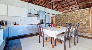 a kitchen with a table and chairs in a room at Holiblue in Blue Bay