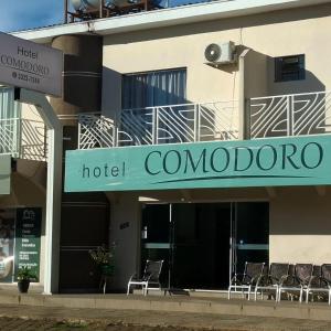 a hotel connector sign on the side of a building at Hotel Comodoro in Vilhena