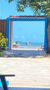 a view of a beach with boats in the water at Casa Passarela in Icapuí
