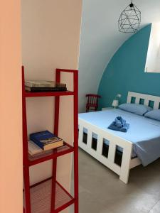 a bedroom with a bed and a red shelf at Levante al porto in Bisceglie