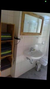 a bathroom with a sink and a mirror at Seglerblick in Greifswald +20 photos