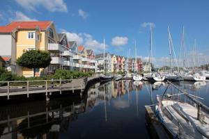 a marina with many houses and boats in the water at Seglerblick in Greifswald