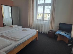 a hotel room with two beds and a window at Hotel Praděd in Jeseník
