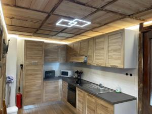 a kitchen with wooden cabinets and a sink in it at Le Flocon de neige in Valtournenche +41 photos