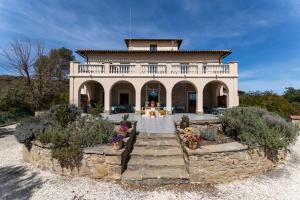 a large house with a dog in front of it at La Torre del Vilar in Santa Eulalia de Ríuprimer
