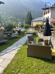 a group of couches sitting on the grass at Le Flocon de neige in Valtournenche