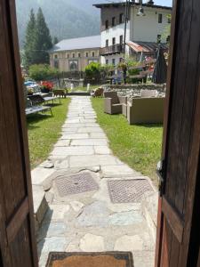 an open door with a stone walkway leading to a building at Le Flocon de neige in Valtournenche