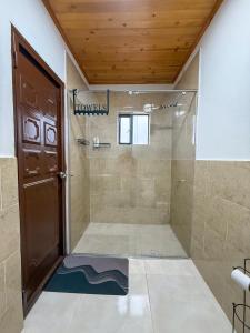 a shower with a glass door in a bathroom at Finca Siberia, Sisga in Tilatá +34 photos