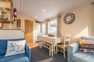 a small living room with a table and a chair at Captain's Quarters B67 in Brixham