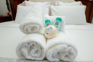 a pile of towels and toothbrushes on a bed at Holiblue in Blue Bay +55 photos