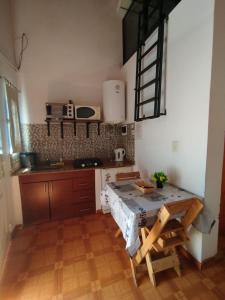 a kitchen with a table and a counter top at La Serena Cabañas in Potrero de los Funes