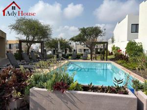 a swimming pool at a holiday house with chairs and plants at AdyHouse Ziré in Buena Vista