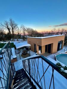 a house with a swimming pool in the snow at Melody in Kapela