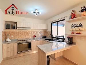 a kitchen with a large counter top and a large window at AdyHouse Ziré in Buena Vista
