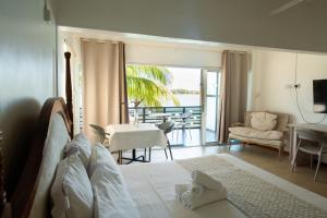 a bedroom with a bed and a living room at Holiblue in Blue Bay