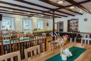 a dining room with wooden tables and chairs at Anna in Miłków