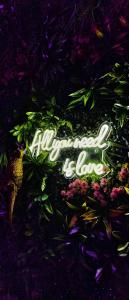 a sign that says allamalaolisja in front of flowers at Suite Passion - Jacuzzi privé - Table massage in Saint-Étienne +17 photos