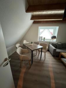 a living room with a table and chairs and a couch at Auental in Husum