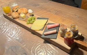 a cutting board with cheese and other foods on a table at B&B Mirre in Kapelle