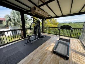 a gym with a balcony with a view of the mountains at Anahari Centro Wellness in Quimbaya