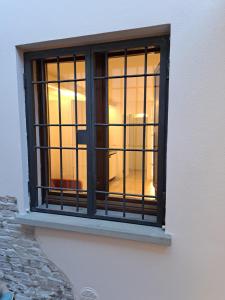 a window with black bars on a white wall at Borgo Piccolo in Imola