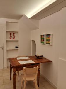 a dining room with a wooden table and chairs at Borgo Piccolo in Imola