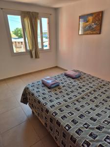 a bedroom with a bed with two pillows on it at Rent Santa Clara in Santa Clara del Mar