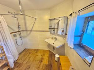 a bathroom with a sink and a shower at Ferienhaus "Bodenschneid" am Schliersee in Schliersee