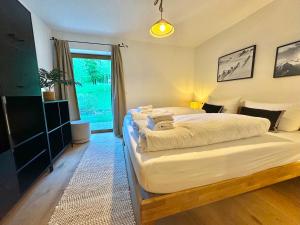 a bedroom with two beds and a large window at Ferienhaus "Bodenschneid" am Schliersee in Schliersee +18 photos