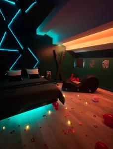 a bedroom with a bed with lights on the floor at Suite craz'in Love Room, jacuzzi, cinéma, climatisation, parking in Beaucaire
