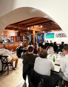 a group of people sitting at tables in a restaurant at Hotel Restaurant Elissaldia in Bidart