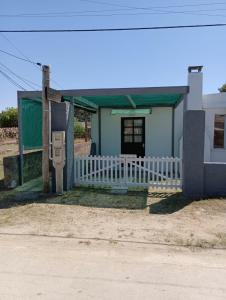 a small house with a fence and a pay phone at Casa Orión in La Paloma