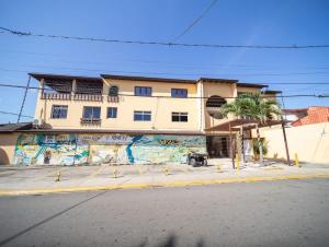 a building with a mural on the side of a street at Colonial 2BR Apartment 2 mins walk to beach in Sosúa
