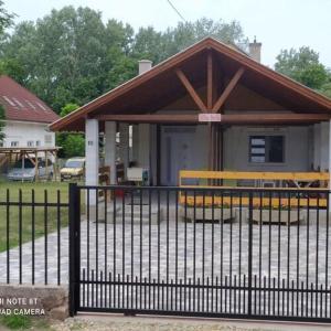 a small house with a fence in front of it at Villa Bella in Szántód