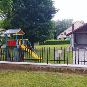 a playground with a slide in a park at Villa Bella in Szántód