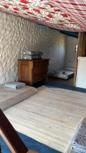 a room with two beds and a dresser in a tent at Rancho Tres11 in Cabo Polonio +5 photos