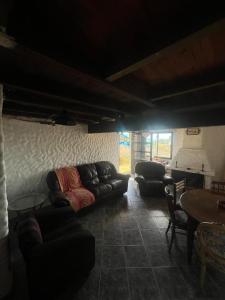a living room with couches and a table at Rancho Tres11 in Cabo Polonio