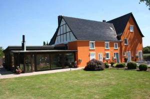 a large orange house with a black roof at 115 qm Apartment für bis zu 8 Personen mit 4 Schlafzimmern in Lünen