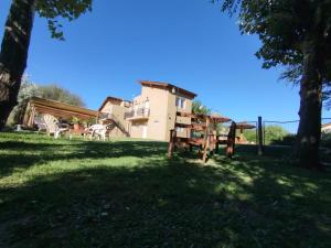 a group of animals standing in the grass near a house at La Serena Cabañas in Potrero de los Funes