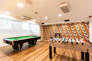 two pool tables in a room with a wall at Haka House Wellington in Wellington